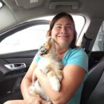 Lori holding Australian Shepherd puppy Skye on gotcha day