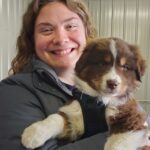 Jayme holding Australian Shepherd puppy Gilbert on gotcha day