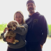 family with their Australian Shepherd puppy on go home day